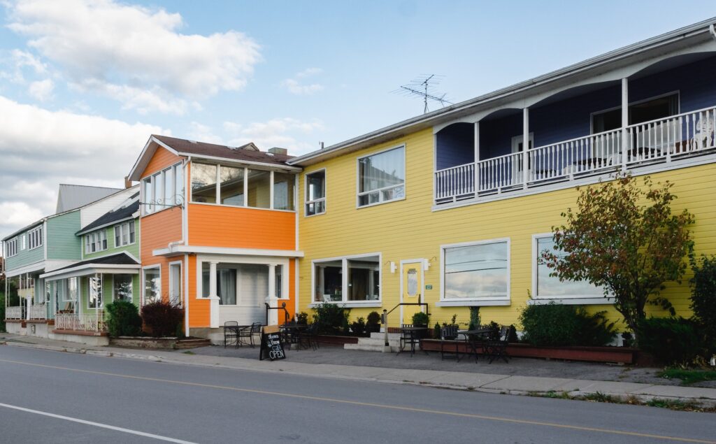 The exterior of Hotel Wolfe Island, showcasing its colourful facade.